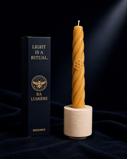 Handcrafted beeswax Bee candle in natural travertine candle holder by Ra Lumière