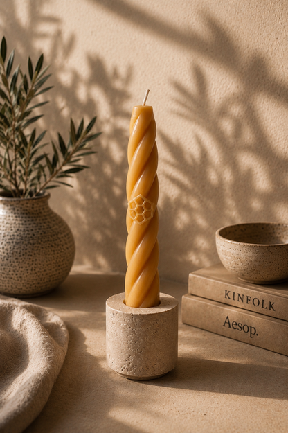 Handcrafted beeswax Bee candle in natural travertine candle holder by Ra Lumière. serene natural interior